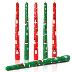 four green candles with snowmen on them