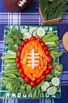 a football shaped veggie platter on a table