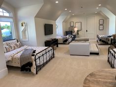 a large bedroom with white walls and carpeted flooring is pictured in this image