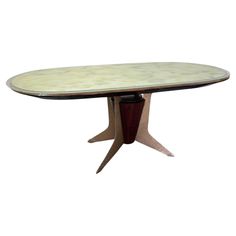 an oval dining table with two leaves on the top and one leaf at the base