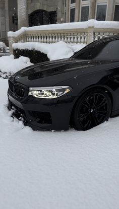 a black car is parked in the snow