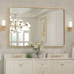 a bathroom with a large mirror above the sink