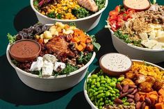 four bowls filled with different types of food on top of a green tableclothed surface