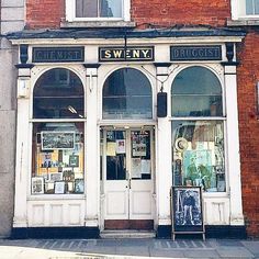 an old brick building with many windows and signs