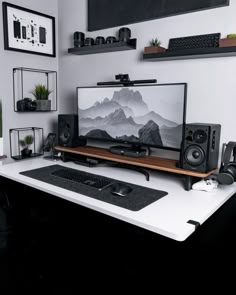 there is a computer on the desk with speakers