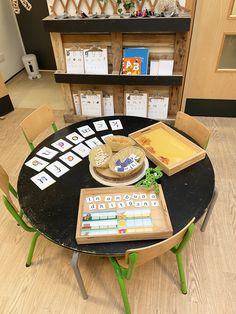 a table with some food on it in front of a book shelf filled with children's books