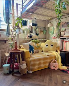 a living room filled with lots of furniture and bookshelves covered in stuffed animals