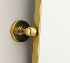 a close up of a door handle on a white and gold colored door with an oval knob