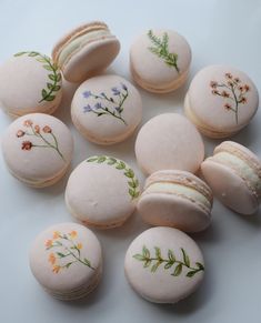 nine macaroons decorated with flowers and leaves