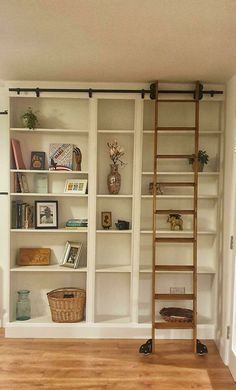 a ladder is leaning against the wall next to a bookshelf