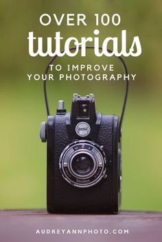 an old camera sitting on top of a wooden table with the words over 100 tutors to improve your photography