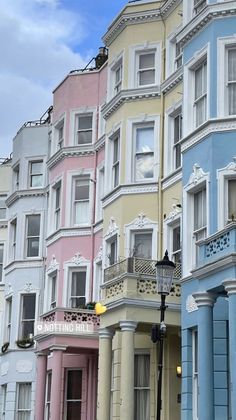 several multi - colored buildings line the street in front of each other