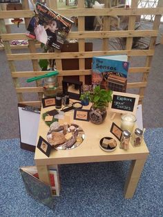 a wooden table topped with lots of different types of food and decorations on it's sides