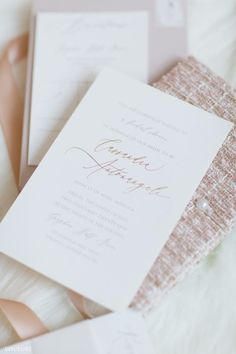 the wedding stationery is laid out and ready for guests to arrive