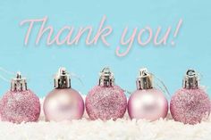 pink christmas ornaments in front of a blue background with the words thank you written on it