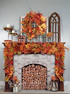 a fireplace decorated with fall leaves and candles