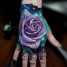 a person's hand painted with an image of a rose and stars on it