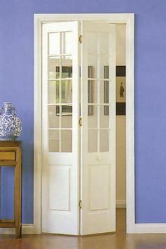 a room with blue walls and white trim on the doors is pictured in this image