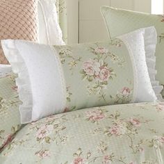 the comforter is made up with pink flowers and white polka doting on it