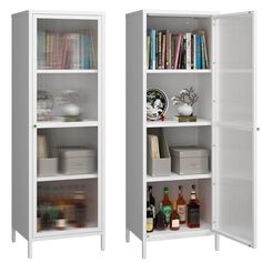 two white bookcases filled with books next to each other and bottles on the shelves