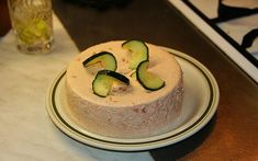 a cake with cucumbers on it sitting on a plate