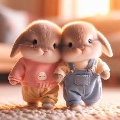 two small rabbits are standing next to each other on the floor, one is wearing overalls