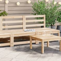 an outdoor seating area with potted plants and lights