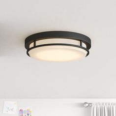 a ceiling light that is hanging from the ceiling in a room with white walls and curtains