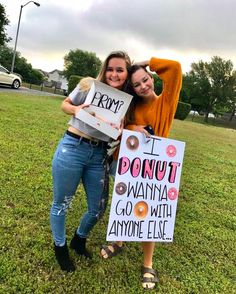 two girls holding signs that say i donut wanna go with anyone else and from