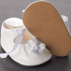 Tallina's White Rosette Baby Doll Shoes. Complete your doll's ensemble with this pair of must-have Tallina's White Rosette Baby Doll Shoes!    Every outfit needs the perfect pair of shoes. With these fashionable baby doll shoes, you can make sure your doll steps up their style for any occasion. Perfect for doll making, baby shower favors, and more.    What size shoes will fit my doll?  Just like people, dolls have different sized feet. Using a cloth measuring tape with millimeter increments, measure for the length of your doll's foot from heel to toe then measure the at the widest point for the width. You can also trace the doll's foot on a sheet of blank paper to measure the length and width. If measuring bare feet, add an additional 5 millimeters to the length to ensure a correct fit. Baby Doll Shoes, Fashionable Baby, Shoes Socks, Blank Paper, Doll Shoes, Measuring Tape, Shower Favors, Doll Making, Baby Shower Favors