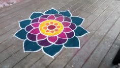 a colorful flower is painted on the ground