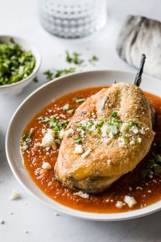 a white plate topped with meat covered in sauce