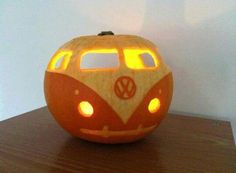 a carved pumpkin shaped like a vw bus with lights on it's side