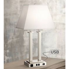 a white lamp sitting on top of a wooden table