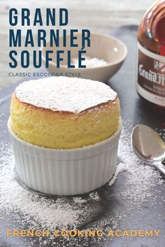 a close up of a cake in a pan with powdered sugar on the top