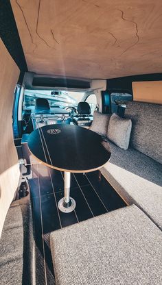 the inside of a camper with couches and tables