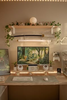 a desk with a computer, keyboard and mouse on it in front of a painting