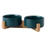 two blue bowls on wooden stand with white background