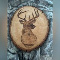 a deer's head is engraved on a tree slice that has been cut in half