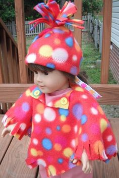 a doll is wearing a colorful outfit and hat