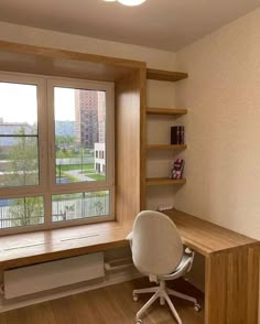 a chair and desk in front of a window with bookshelves on either side