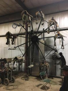 a large clock made out of various types of equipment in a building with people looking at it