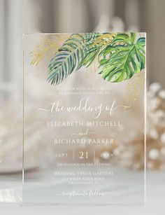 the wedding of elizabeth mitchell and richard parker is displayed in front of a table with white flowers