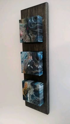 a wooden wall shelf with three boxes on it's sides, hanging from the wall