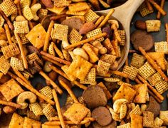 a wooden spoon filled with cheetos and dog treats on top of a table