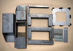 there are many different metal frames on the wall, including one that has been cut in half