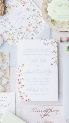 the wedding stationery is laid out on top of each other