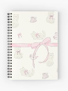 a spiral notebook with pink ribbon and teddy bears on it, all over the page