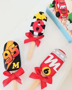 three lollipops are decorated to look like the characters from cars