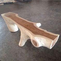 a wooden bench sitting on top of a floor